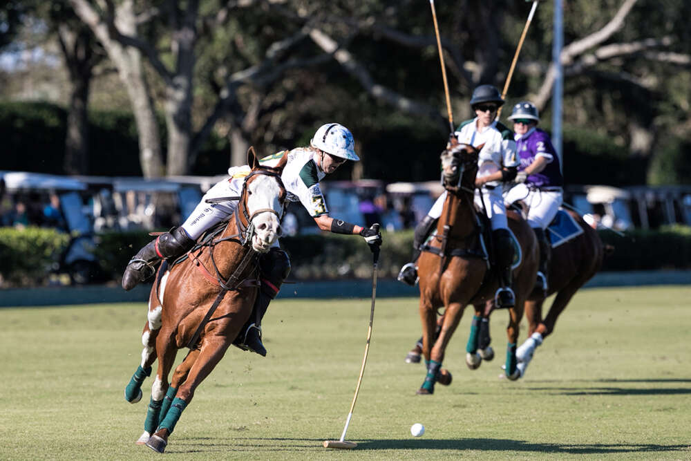 Lauren Biddle of The Villages sweeps the ball on the nearside during semifinal play against Arden's Fine Jewelers. 