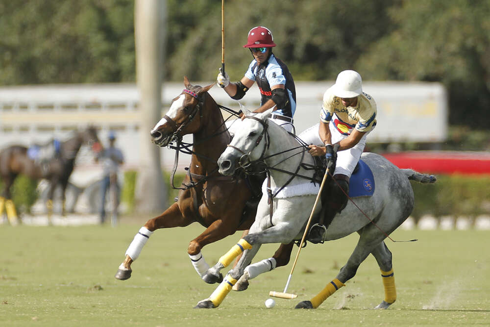 Colorado's Magoo Laprida carries the ball on the nearside, Alejandro Novillo Astrada of Grand Champions Polo Club on defense. 