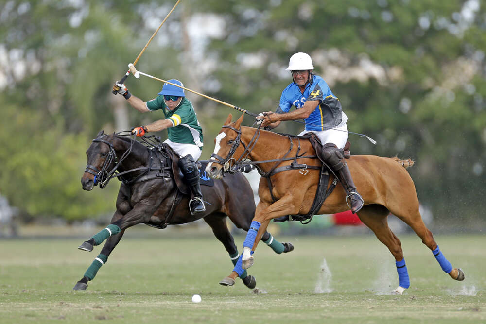 Sapo Caset and Popular race down field at top speed against GSA's Matias Magrini during the 2018 Ylvisaker Cup at International Polo Club Palm Beach. 