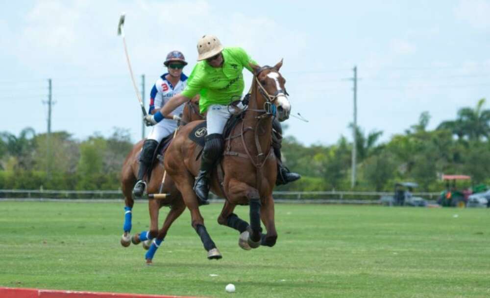 Julio Gracida of ChukkerTV goes for the big hit downfield with Lucas Diaz Alberdi of Sebucan defending